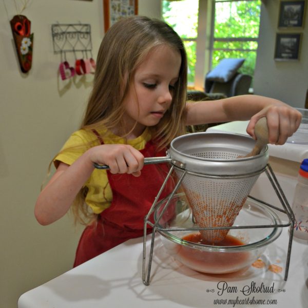 ketchup-making-nora-straining-out-juice-and-pulp